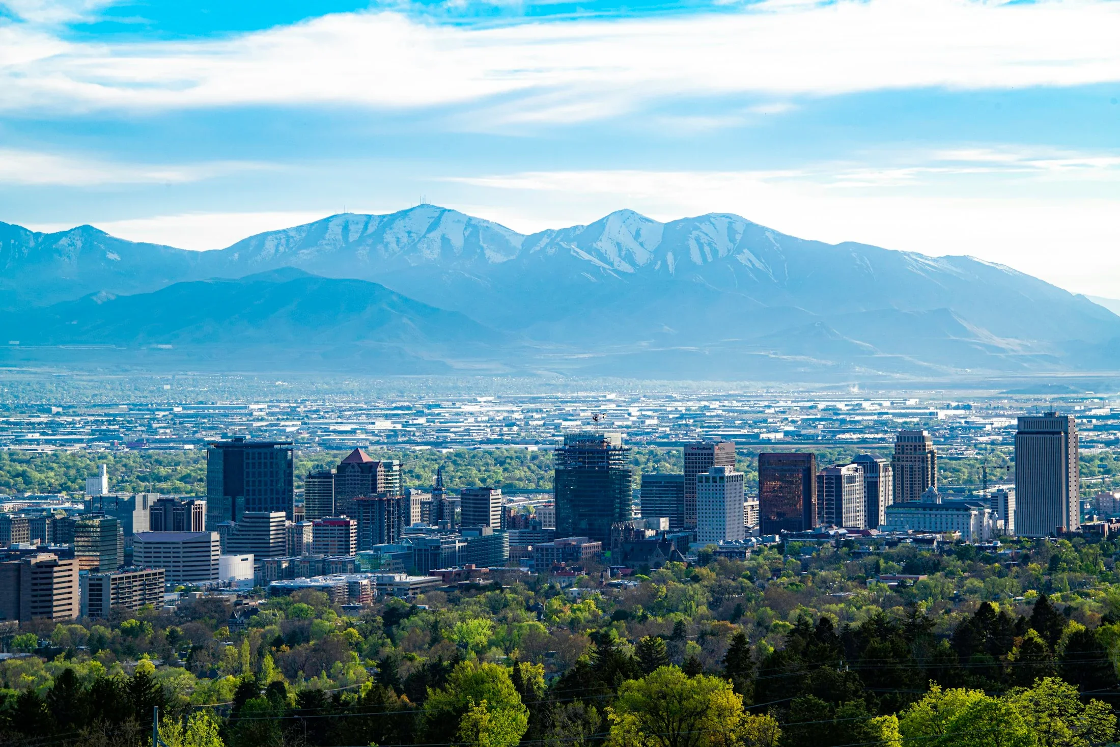 Salt Lake City neighborhoods and downtown buildings beneath the mountains